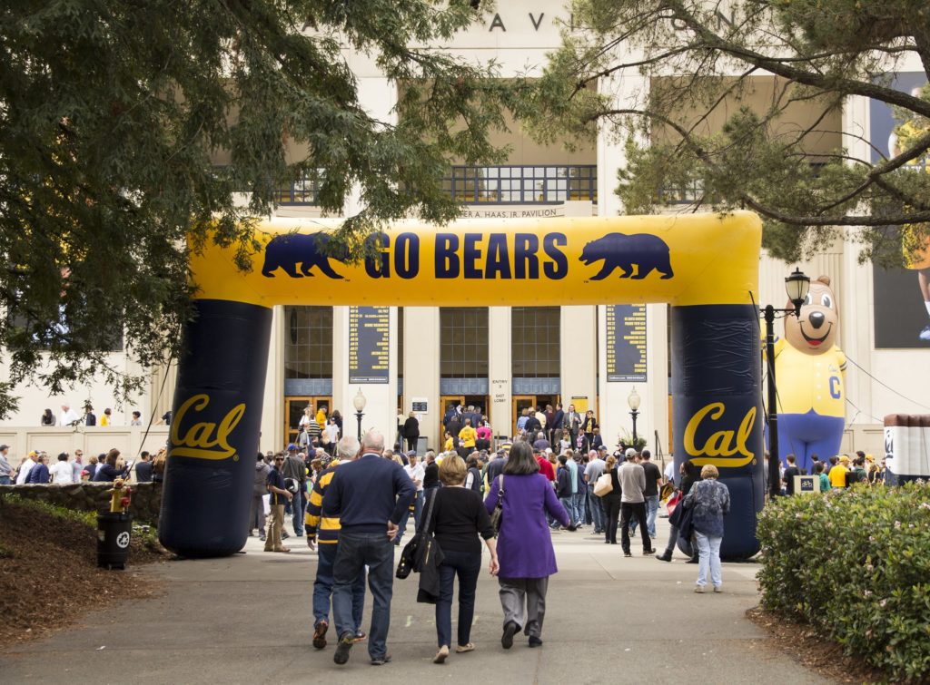 people walk through inflatable gameday arch